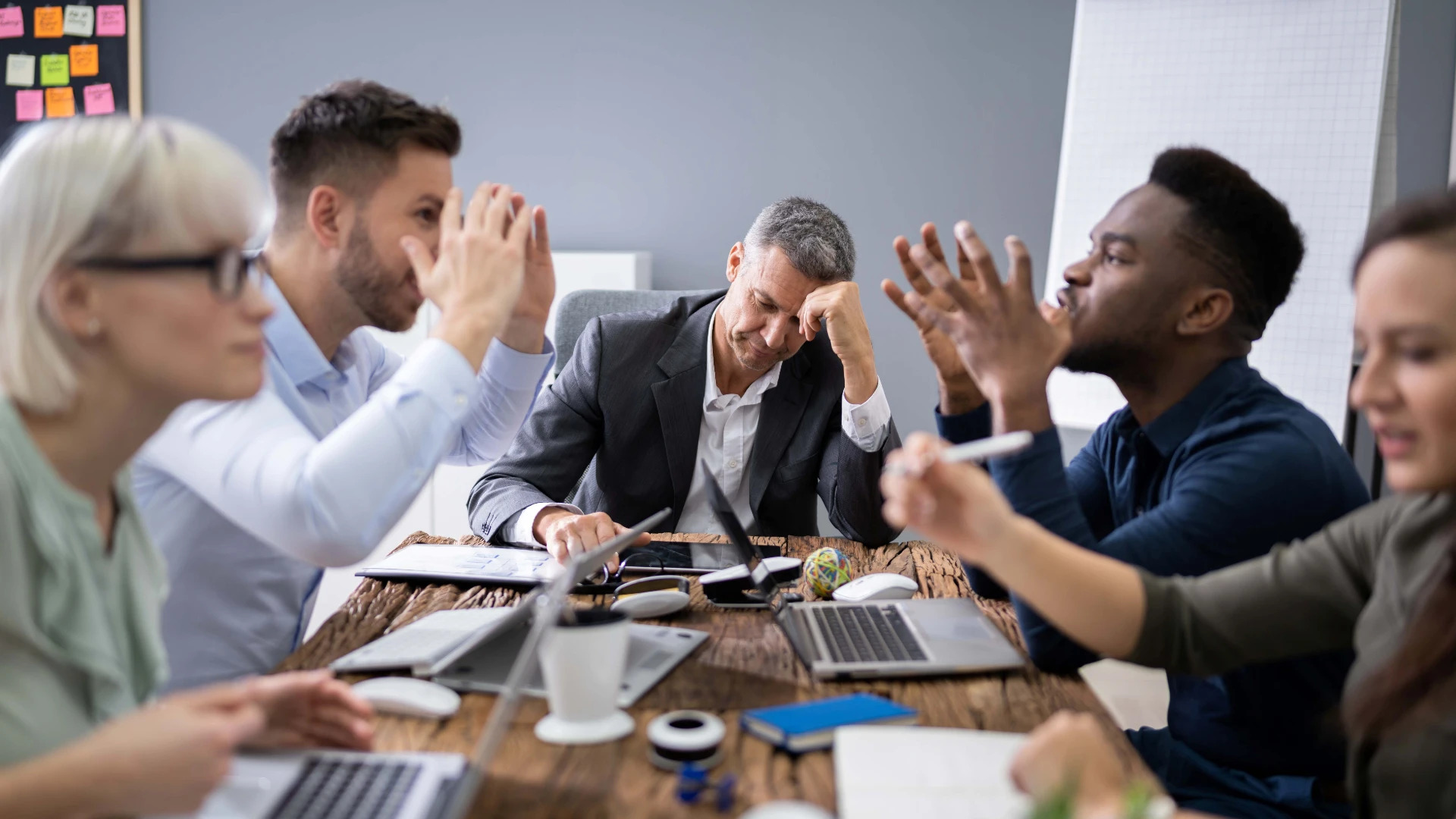 employees arguing in a meeting