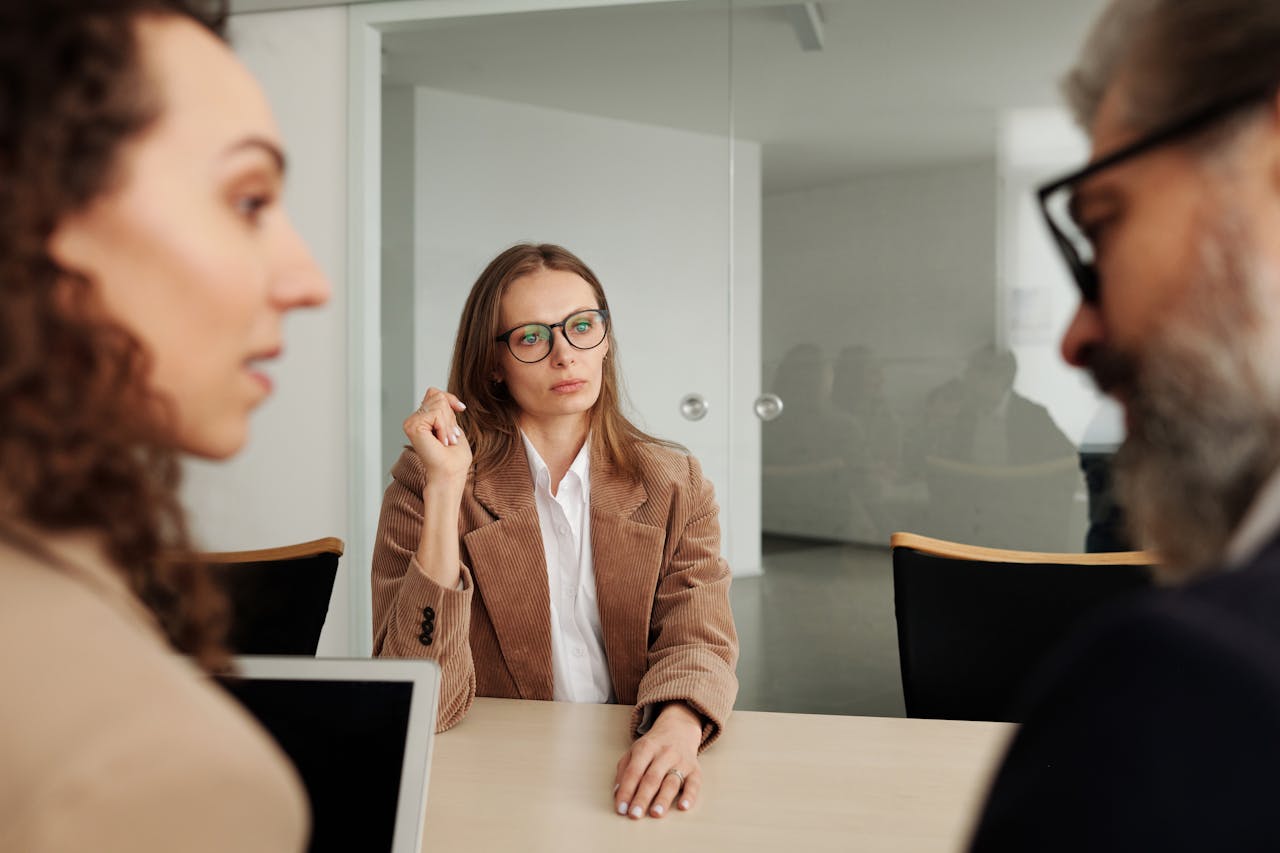 External workplace investigator listens to two employees during an investigation interview meeting